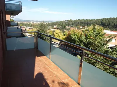 a balcony with a view of a city at Aparthotel del Golf in Sant Cugat del Vallès