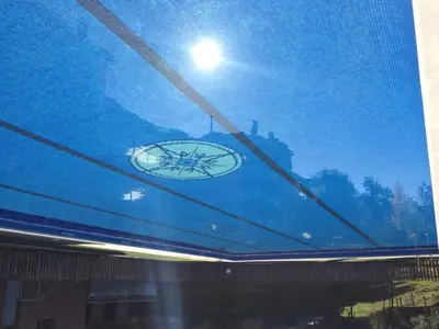 a reflection of a clock on a glass window at Aparthotel del Golf in Sant Cugat del Vallès