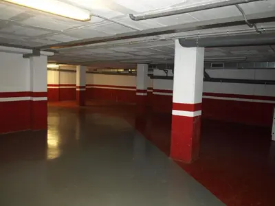 an empty room with red and white columns in a building at Aparthotel del Golf in Sant Cugat del Vallès