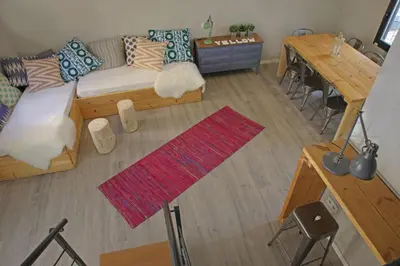 a living room with a couch and a table at Fridays Flats Casa Lemonade in Hospitalet de Llobregat