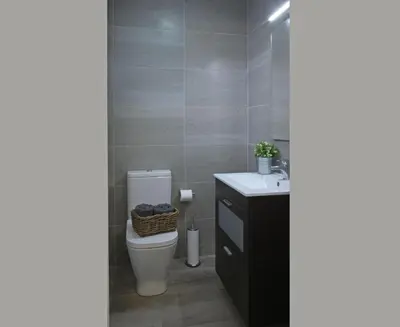 a bathroom with a toilet and a sink at Fridays Flats Casa Lemonade in Hospitalet de Llobregat