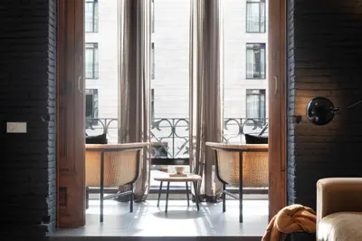 a room with a large window with chairs and tables at DestinationBCN Universitat Apartments in Barcelona