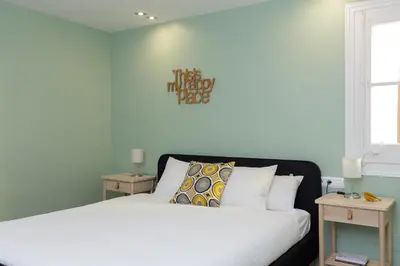 a bedroom with two beds and a sign on the wall at Casa Cosi - Mallorca 3 in Barcelona