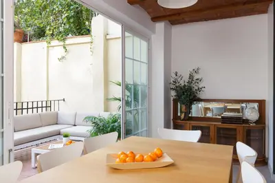 a dining room with a table with oranges on it at Casa Cosi - Mallorca 3 in Barcelona