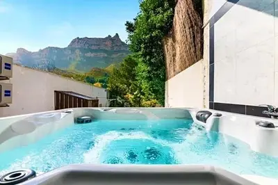 a bath tub with a view of a mountain at Barceló Apartaments in Monistrol