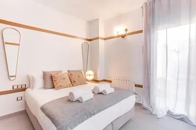 a bedroom with a white bed with towels on it at Sweett - Callao Plaza in Barcelona
