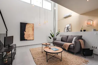 a living room with a couch and a table at Sweett - Callao Plaza in Barcelona