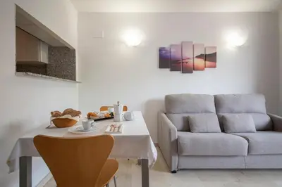 a living room with a table and a couch at Aparthotel Marsol in Castelldefels