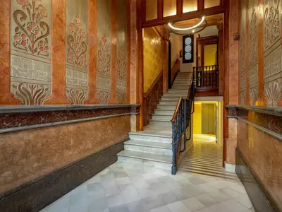 a hallway with stairs in an old building at Central Apartments Barcelona in Barcelona