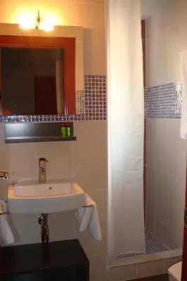 a bathroom with a sink and a shower with a mirror at Casablanca Suites - Adults Only in Calella