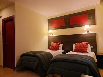 a hotel room with two beds with red pillows at Casablanca Suites - Adults Only in Calella