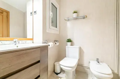 a bathroom with a white toilet and a sink at Confort Barcelona Rentals in Barcelona