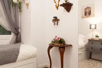 a bedroom with a bed and a table with flowers on it at Rambla Poblenou&Mar Bella Beach in Barcelona