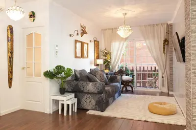 a living room with a couch and a table at Rambla Poblenou&Mar Bella Beach in Barcelona