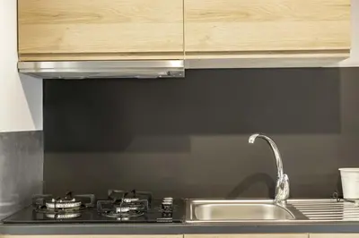 a kitchen counter with a sink and a stove at NEW Renovated COZY APPARTMENT CENTRIC in Barcelona