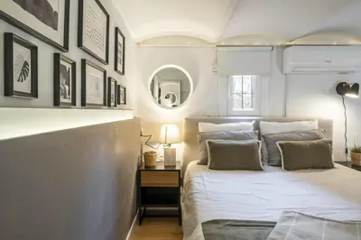 a bedroom with a large bed and a mirror at NEW Renovated COZY APPARTMENT CENTRIC in Barcelona