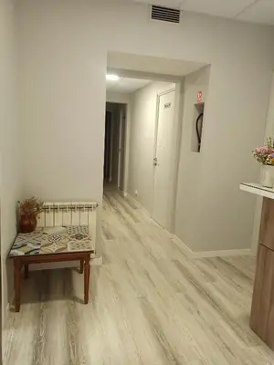 an empty room with a bench and a hallway at Hostal Ruta de Francia in Barcelona