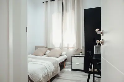 a bedroom with a bed and a window at Hostal Ruta de Francia in Barcelona