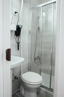 a bathroom with a shower and a toilet and a sink at Hostal Ruta de Francia in Barcelona