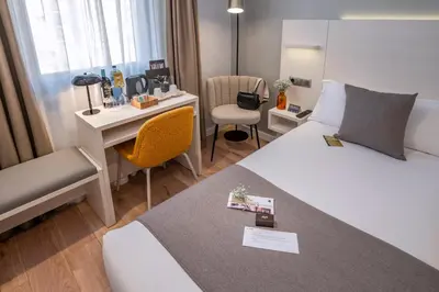 a hotel room with a bed and a desk at SERHS Carlit Boutique Hotel in Barcelona