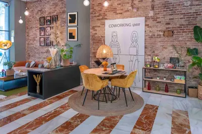 a furniture store with a table and chairs in a room at SERHS Carlit Boutique Hotel in Barcelona