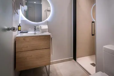 a bathroom with a sink and a mirror at SERHS Carlit Boutique Hotel in Barcelona