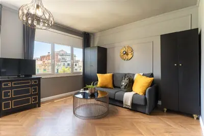 a living room with a couch and a tv at TSA Gran Via in Barcelona