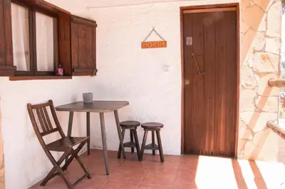 a small table and two stools in a room at Pinedes Verd in La Torre de Claramunt