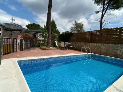 a swimming pool in a yard next to a fence at Pinedes Verd in La Torre de Claramunt