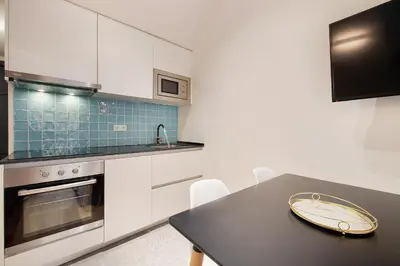 a kitchen with a black table and a sink at Aqua Apartment by Olala Homes in Barcelona