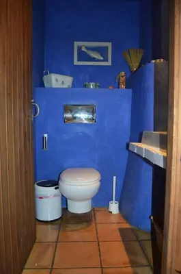 a blue bathroom with a toilet and a sink at Entre Olivos: Very Charming Villa 18 SLEEPERS in Sant Pere de Ribes