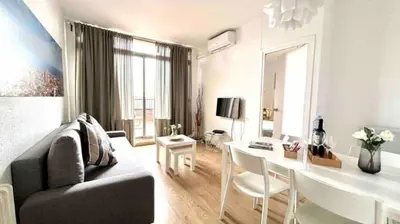 a living room with a couch and a dining room at SANTS STATION PENTHOUSE in Barcelona