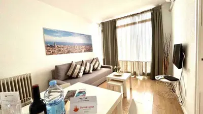 a living room with a couch and a table at SANTS STATION PENTHOUSE in Barcelona