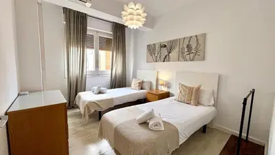 a small room with two beds and a mirror at Sagrada Familia - Sant Pau apartment in Barcelona