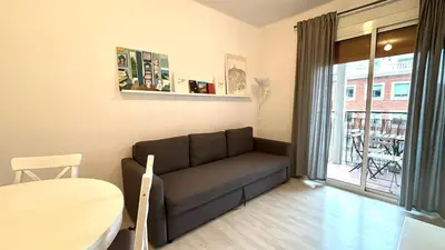 a living room with a table and a couch at Sagrada Familia - Sant Pau apartment in Barcelona