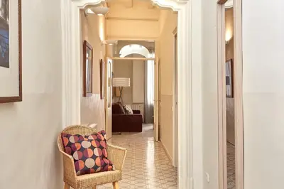 a hallway with a chair with a pillow on it at Casa Cosi - Gotico in Barcelona