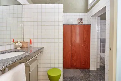 a bathroom with a sink and a wooden door at Casa Cosi - Gotico in Barcelona