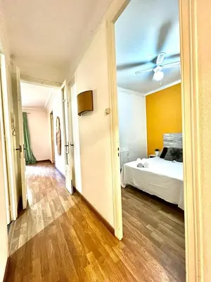 a bedroom with a bed and a ceiling fan at Big and Bright Apartment BCN in Barcelona
