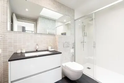 a bathroom with a toilet and a sink and a shower at Aspasios Paseo de Gracia Apartments in Barcelona