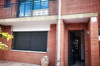 a brick building with a balcony and a door at Comfortable house near Esparreguera with city view in Esparreguera