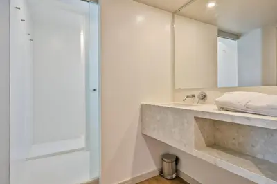a bathroom with a sink and a mirror at My Address in Plaza Real in Barcelona