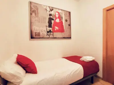 a bedroom with a bed and a picture on the wall at Bed&BCN Gracia II in Barcelona