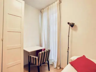 a bedroom with a bed and a desk and a chair at Bed&BCN Gracia II in Barcelona