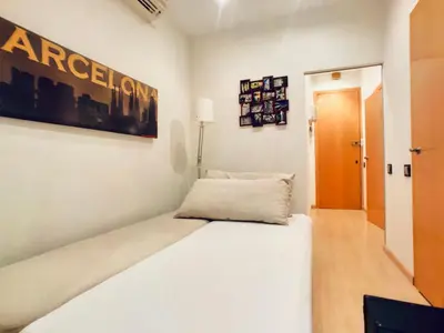 a bedroom with a large white bed in a room at Bed&BCN Gracia II in Barcelona