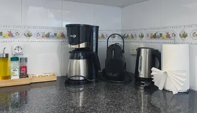 a kitchen with a coffee maker on a counter at Stay U-nique Apartments Lepant in Barcelona