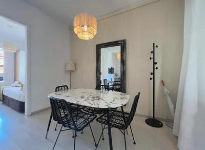 a dining room with a table and chairs and a mirror at Stay U-nique Apartments Lepant in Barcelona