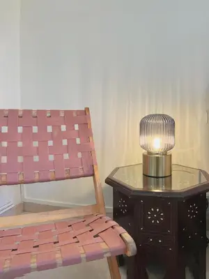a lamp and a chair next to a table at Stay U-nique Apartments Lepant in Barcelona