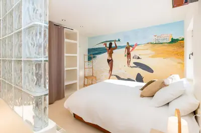 a bedroom with a white bed and a window at Stunning Villa Ibizenca with private pool in Sitges in Sitges
