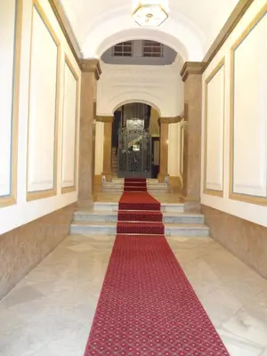 a red carpet in the hallway of a building with a red floor at Hostal Sant Carlo in Barcelona