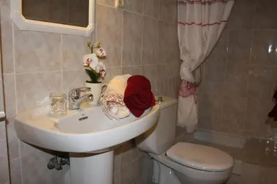 a bathroom with a sink and a toilet at PENSIÓN Colmenero in Barcelona